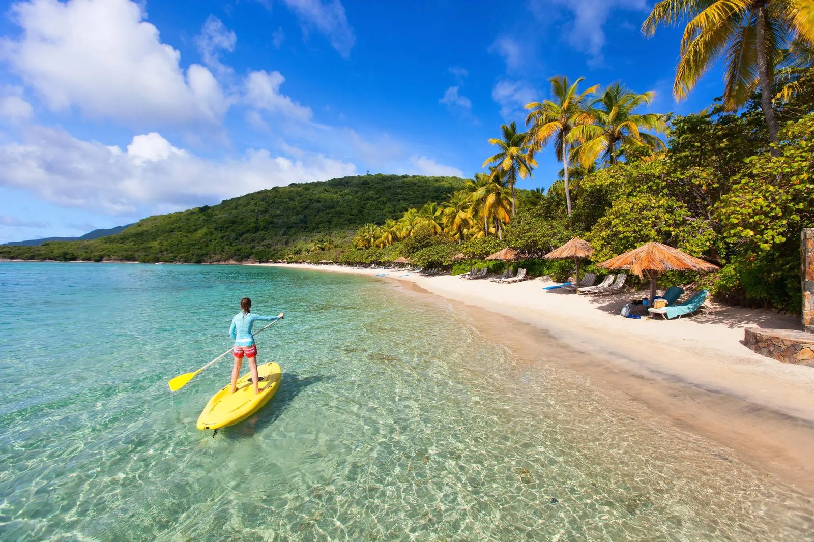 Paddleboarder gliding over clear tropical water