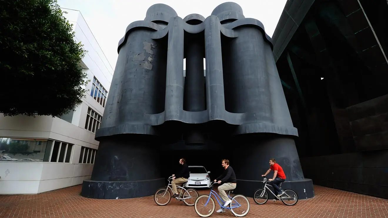 Office building with a giant binoculars sculpture at its entrance